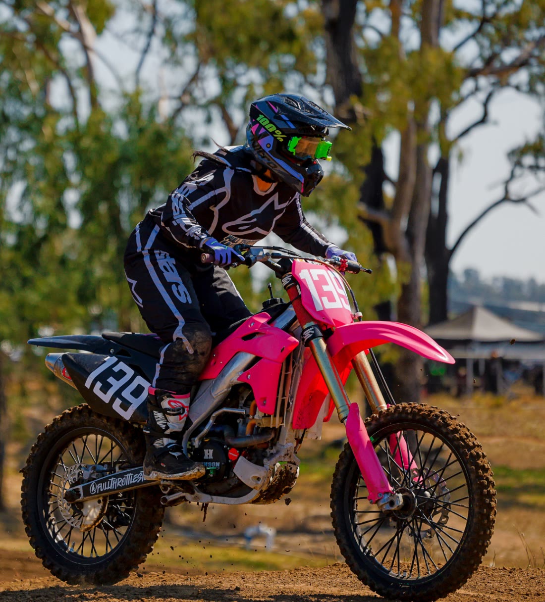 BABY MAMA rider number 139 cornering on a pink motocross bike